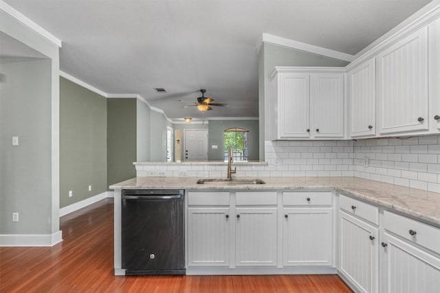 1011 Moser River Dr, Leander, TX 78641 - kitchen with dishwashing machine, a sink, crown molding, backsplash, and white cabinetry