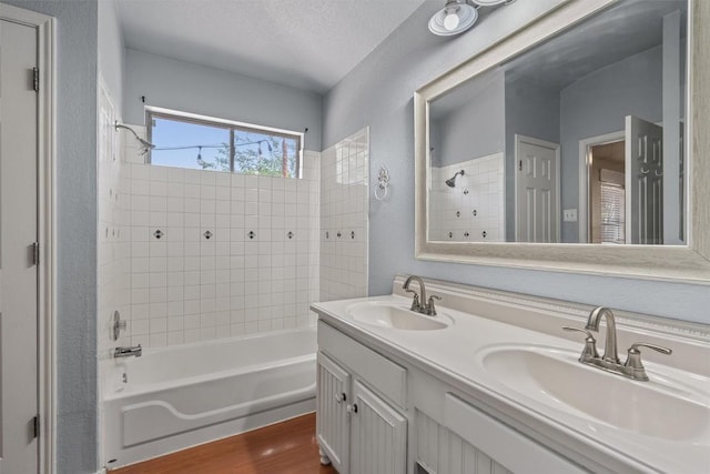 1011 Moser River Dr, Leander, TX 78641 - full bath with bathing tub / shower combination, double vanity, and wood finished floors