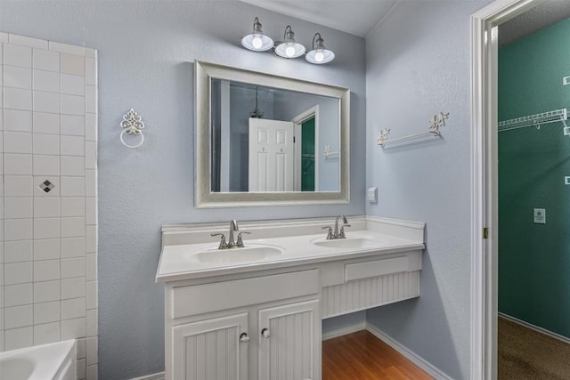 1011 Moser River Dr, Leander, TX 78641 - bathroom with double vanity, shower / tub combination, and baseboards