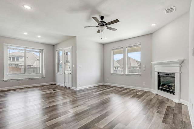 1905 Mariann Dr, Leander, TX 78641 - unfurnished living room featuring plenty of natural light, wood finished floors, a ceiling fan, and recessed lighting