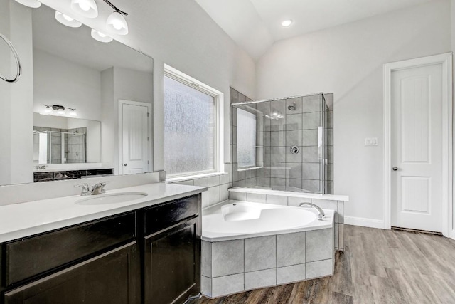 1905 Mariann Dr, Leander, TX 78641 - full bath with a bath, vanity, wood finished floors, and tiled shower