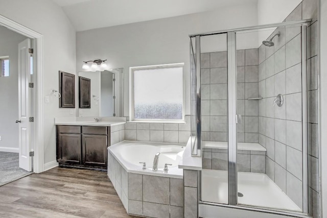 1905 Mariann Dr, Leander, TX 78641 - bathroom with a garden tub, vanity, a shower stall, and wood finished floors