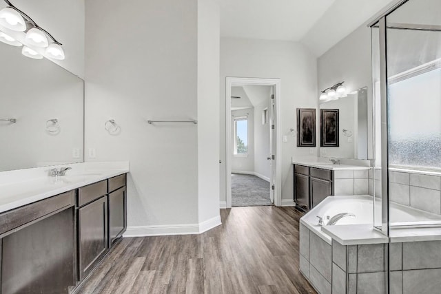 1905 Mariann Dr, Leander, TX 78641 - full bathroom featuring wood finished floors, vanity, and a bath