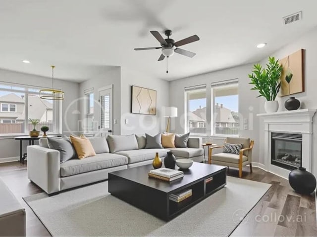 1905 Mariann Dr, Leander, TX 78641 - living room featuring wood finished floors, recessed lighting, ceiling fan, and a glass covered fireplace