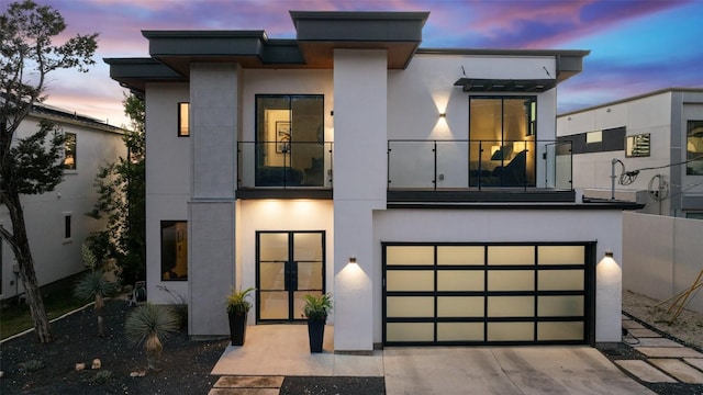 14417 Cochise Trl, Austin, TX 78734 - modern home with a balcony, stucco siding, an attached garage, and concrete driveway