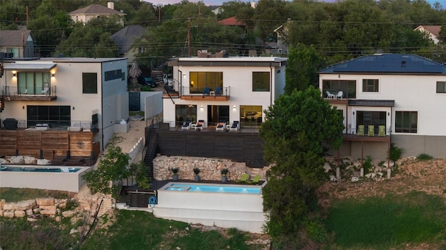 14417 Cochise Trl, Austin, TX 78734 - view of front of property with a balcony, stucco siding, and an outdoor pool