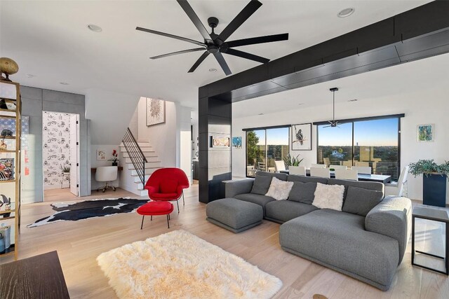 14417 Cochise Trl, Austin, TX 78734 - living room featuring ceiling fan, light wood-style flooring, and stairway