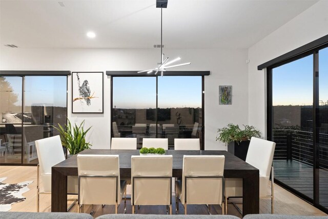 14417 Cochise Trl, Austin, TX 78734 - dining area featuring a chandelier, wood finished floors, plenty of natural light, and recessed lighting