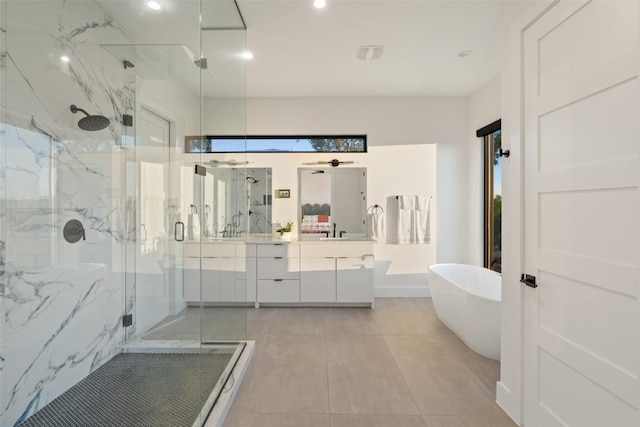 14417 Cochise Trl, Austin, TX 78734 - bathroom featuring a marble finish shower, double vanity, a freestanding tub, tile patterned floors, and recessed lighting