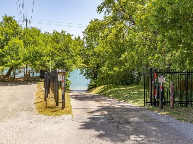 14417 Cochise Trl, Austin, TX 78734 - view of asphalt driveway featuring a gated entry and a gate