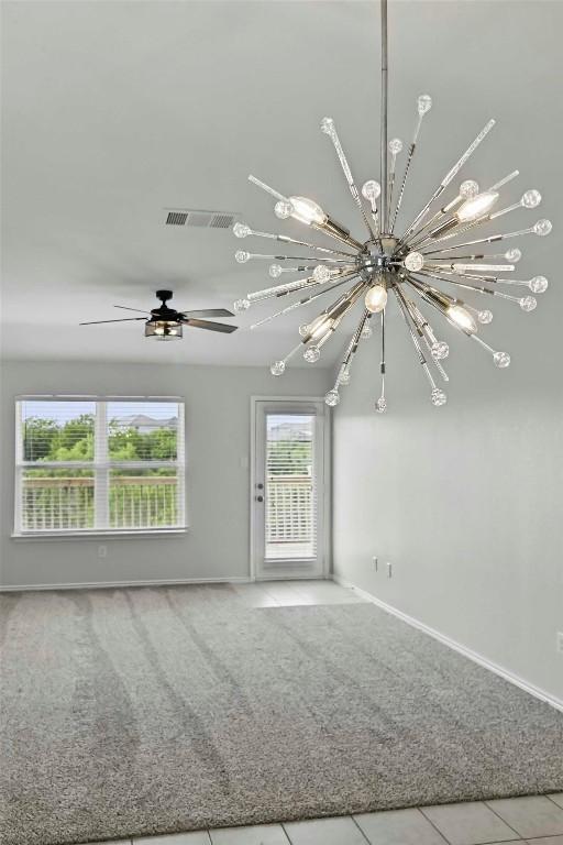 146 Blair Ct, San Marcos, TX 78666 - unfurnished living room featuring a chandelier, carpet, and tile patterned flooring