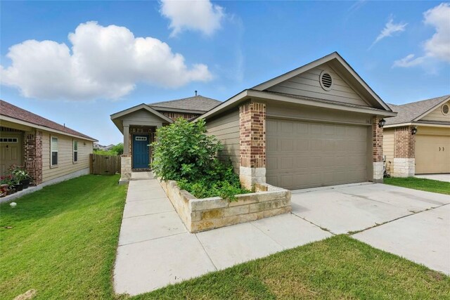 146 Blair Ct, San Marcos, TX 78666 - view of front of property with brick siding, concrete driveway, an attached garage, and a front lawn