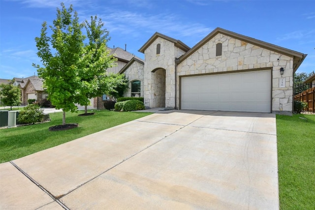 216 Walkup Ln, Leander, TX 78641 - french country inspired facade with stone siding, an attached garage, a front lawn, and concrete driveway