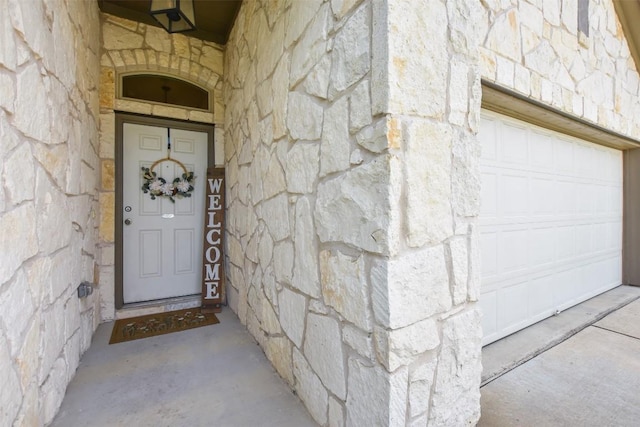 216 Walkup Ln, Leander, TX 78641 - entrance to property with stone siding and a garage