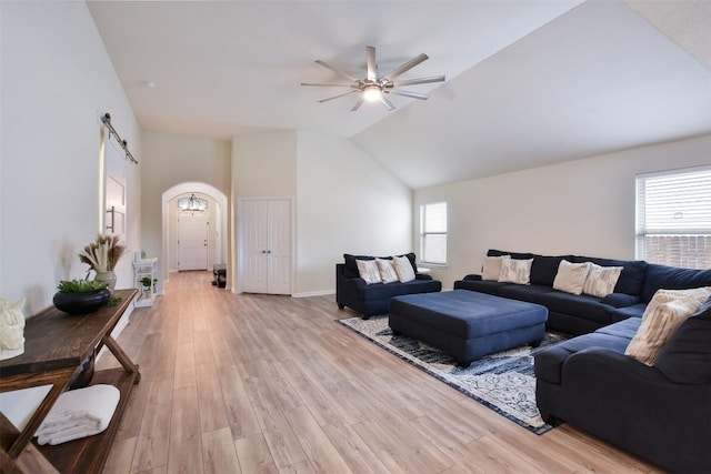216 Walkup Ln, Leander, TX 78641 - living area with a ceiling fan, light wood-type flooring, baseboards, vaulted ceiling, and arched walkways
