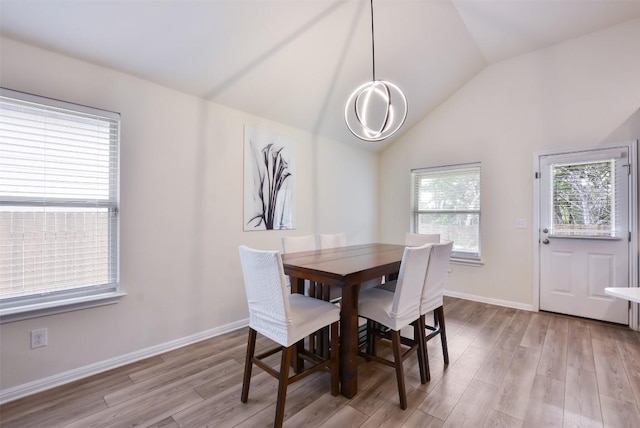 216 Walkup Ln, Leander, TX 78641 - dining room with light wood-style floors, lofted ceiling, and baseboards