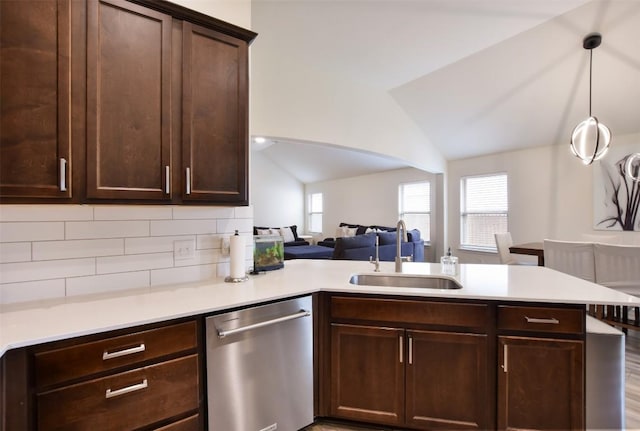 216 Walkup Ln, Leander, TX 78641 - kitchen featuring dishwasher, a sink, a peninsula, open floor plan, and light countertops
