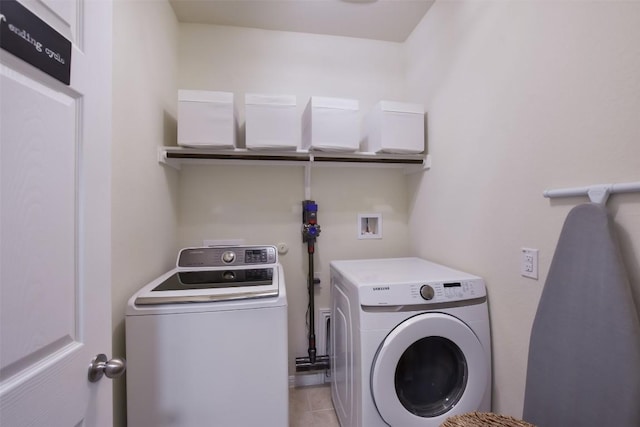 216 Walkup Ln, Leander, TX 78641 - washroom with separate washer and dryer and light tile patterned floors