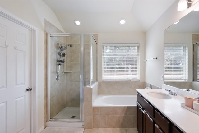 216 Walkup Ln, Leander, TX 78641 - bathroom with a shower stall, a bath, vanity, lofted ceiling, and recessed lighting