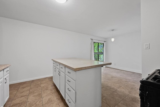 2303 E E Side Dr Unit 102, Austin, TX 78704 - kitchen with white cabinets, black range with gas cooktop, light countertops, light stone finish floors, and a center island