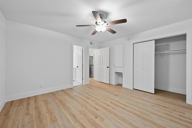 2303 E E Side Dr Unit 102, Austin, TX 78704 - unfurnished bedroom featuring wood finished floors, stainless steel refrigerator, a ceiling fan, and a closet