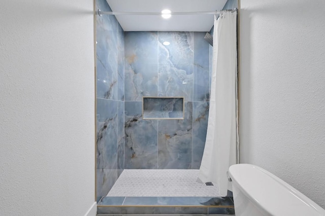 2303 E E Side Dr Unit 102, Austin, TX 78704 - bathroom featuring tiled shower, a textured wall, and a soaking tub