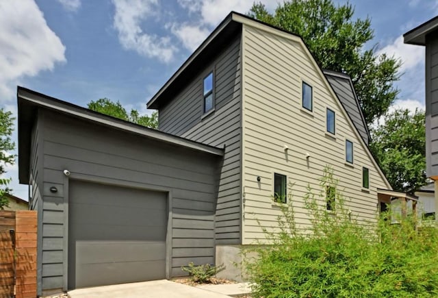 1001 Walter St Unit 2, Austin, TX 78702 - view of home's exterior featuring concrete driveway and an attached garage