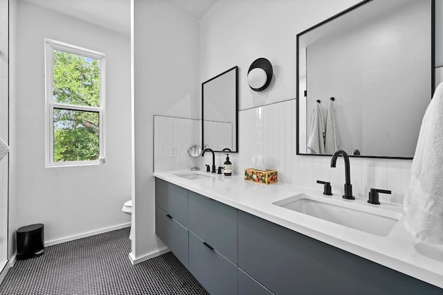 1001 Walter St Unit 2, Austin, TX 78702 - bathroom featuring double vanity, plenty of natural light, and tasteful backsplash