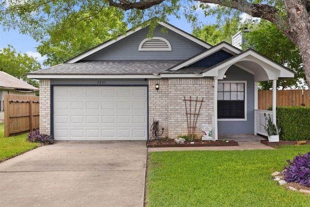 2205 Thornwild Pass, Austin, TX 78758 - view of front of house with concrete driveway, a chimney, brick siding, and a shingled roof
