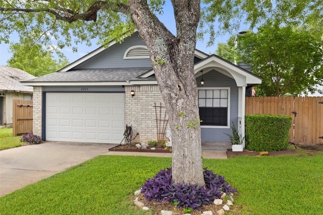 2205 Thornwild Pass, Austin, TX 78758 - view of front facade featuring driveway, brick siding, a garage, and a shingled roof