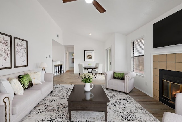 2205 Thornwild Pass, Austin, TX 78758 - living area featuring a ceiling fan, wood finished floors, a fireplace, and lofted ceiling
