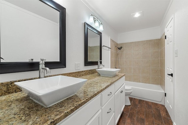2205 Thornwild Pass, Austin, TX 78758 - bathroom with double vanity, wood finished floors,  shower combination, and ornamental molding