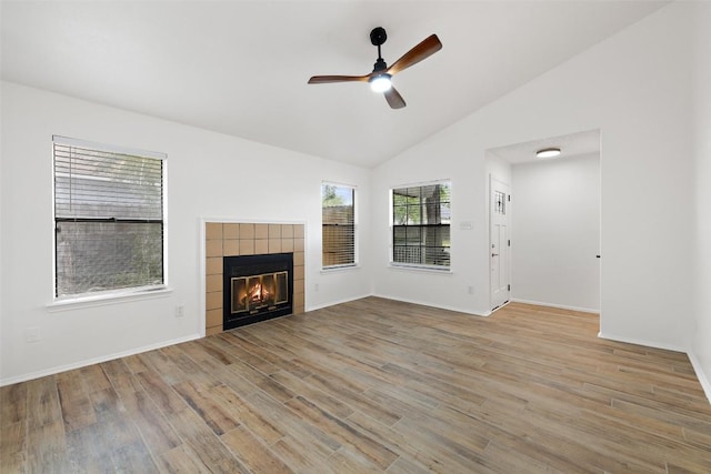 2205 Thornwild Pass, Austin, TX 78758 - unfurnished living room with a ceiling fan, wood finished floors, a fireplace, and high vaulted ceiling