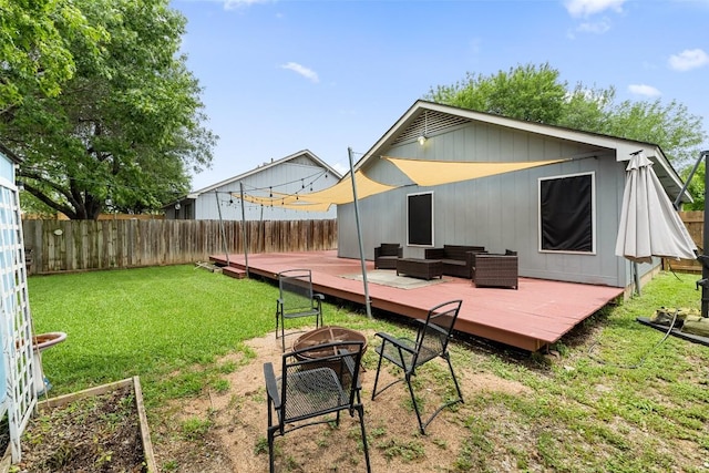 2205 Thornwild Pass, Austin, TX 78758 - back of property featuring a wooden deck, a fenced backyard, and an outdoor living space with a fire pit