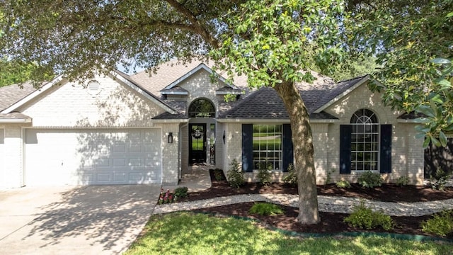 1008 Twin Terrace Ct, Round Rock, TX 78665 - view of front facade featuring brick siding, an attached garage, and roof with shingles