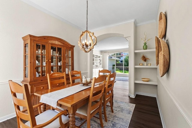 1008 Twin Terrace Ct, Round Rock, TX 78665 - dining room featuring arched walkways, dark wood finished floors, crown molding, a chandelier, and built in shelves