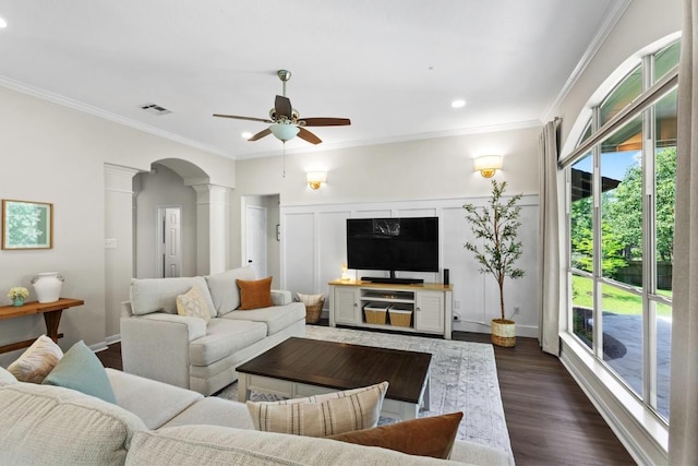 1008 Twin Terrace Ct, Round Rock, TX 78665 - living room featuring ceiling fan, ornate columns, ornamental molding, arched walkways, and dark wood-style floors