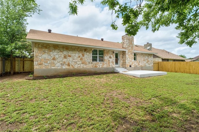 913 Spring Tree St, Round Rock, TX 78681 - rear view of house with stone siding, a chimney, and a patio