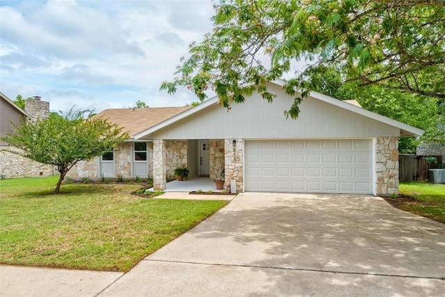 913 Spring Tree St, Round Rock, TX 78681 - view of front of home with stone siding, an attached garage, concrete driveway, a front yard, and cooling unit