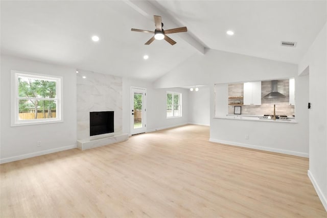 913 Spring Tree St, Round Rock, TX 78681 - unfurnished living room featuring ceiling fan, light wood finished floors, a premium fireplace, baseboards, and recessed lighting