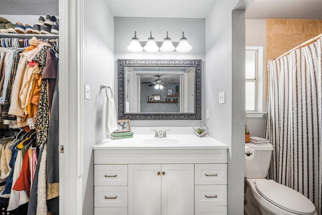 1906 Garden Villa Dr, Georgetown, TX 78628 - full bath featuring vanity, a walk in closet, a shower with curtain, ceiling fan, and a textured wall
