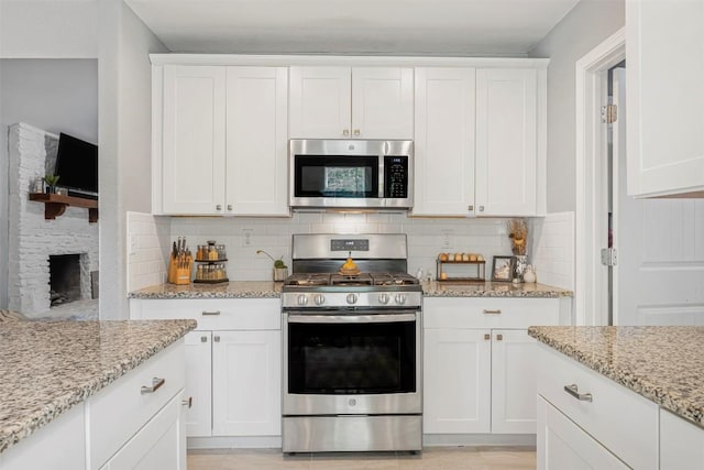 1906 Garden Villa Dr, Georgetown, TX 78628 - kitchen with stainless steel appliances, white cabinetry, and backsplash