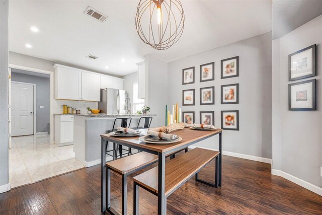1906 Garden Villa Dr, Georgetown, TX 78628 - dining room featuring wood finished floors, a chandelier, and recessed lighting