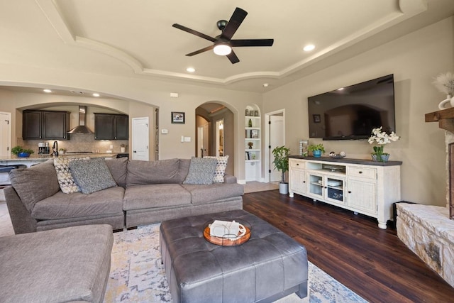 2644 Salorn Way, Round Rock, TX 78681 - living area featuring a tray ceiling, arched walkways, ceiling fan, dark wood-type flooring, and recessed lighting