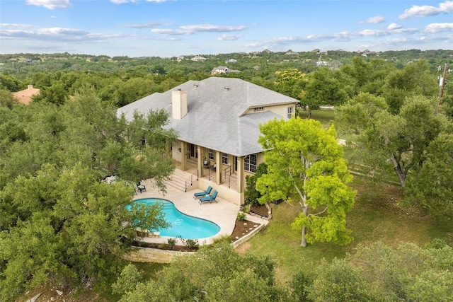 1026 Windmill Rd, Dripping Springs, TX 78620 - view of subject property with a pool and a forest