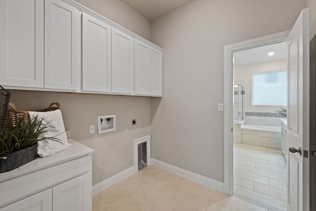1116 Highwater Dr, Georgetown, TX 78628 - laundry room featuring electric dryer hookup, cabinet space, baseboards, and washer hookup