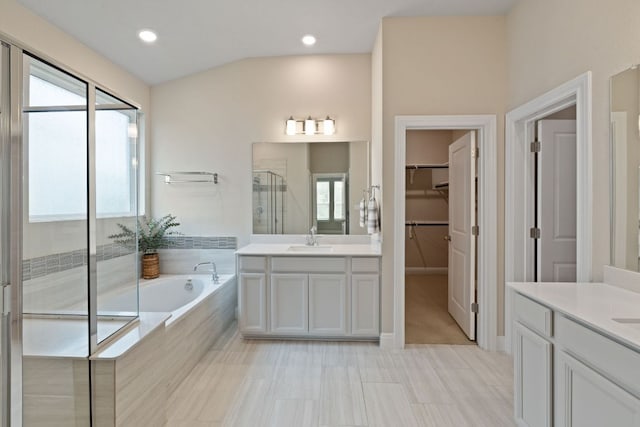 1116 Highwater Dr, Georgetown, TX 78628 - bathroom with two vanities, a stall shower, healthy amount of natural light, and a bath