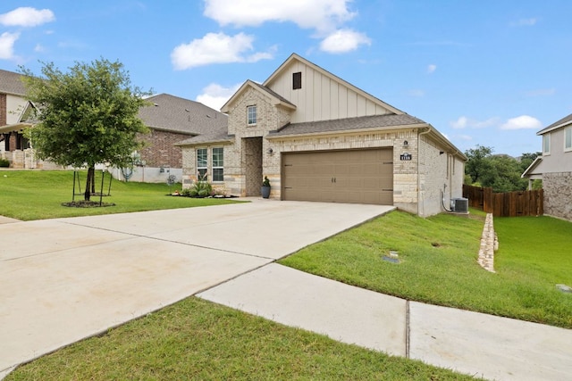 1116 Highwater Dr, Georgetown, TX 78628 - view of front of property featuring board and batten siding, an attached garage, concrete driveway, central air condition unit, and brick siding