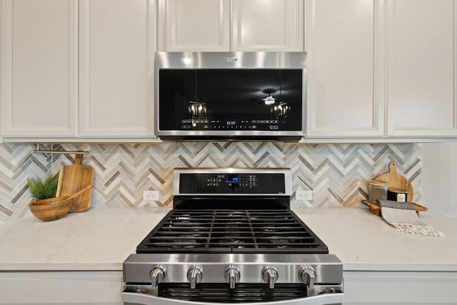 1116 Highwater Dr, Georgetown, TX 78628 - kitchen featuring appliances with stainless steel finishes, white cabinetry, and decorative backsplash