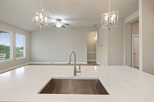1116 Highwater Dr, Georgetown, TX 78628 - kitchen featuring a chandelier, open floor plan, and decorative light fixtures